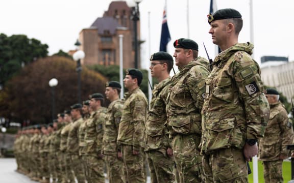 Soldiers rehearse for a military parade in the rain on Parliament's forecourt.