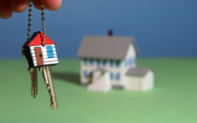 An illustration showing a hand holding keys to a new home.