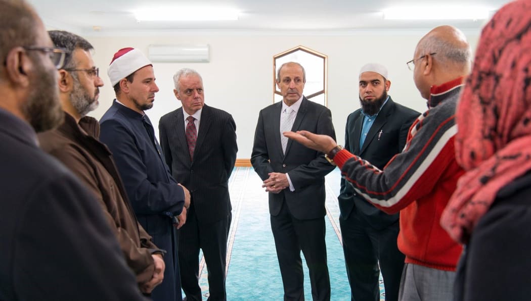 Dr Anwar Ghani (red) takes the Jewish visitors on a tour of a Christchurch Mosque.