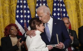 WASHINGTON, DC - JANUARY 6: U.S. President Joe Biden embraces Gladys Sicknick, the mother of late Capitol Police Officer Brian Sicknick, as she accepts a Presidential Citizens Medal on behalf of her late son during a ceremony to mark the two-year anniversary of the January 6th 2021 attack on the U.S. Capitol in the East Room of the White House January 6, 2023. Biden awarded 12 Presidential Citizens Medals to police officers who defended the Capitol and state officials who resisted pressure to overturn the 2020 presidential election results.   Drew Angerer/Getty Images/AFP (Photo by Drew Angerer / GETTY IMAGES NORTH AMERICA / Getty Images via AFP)