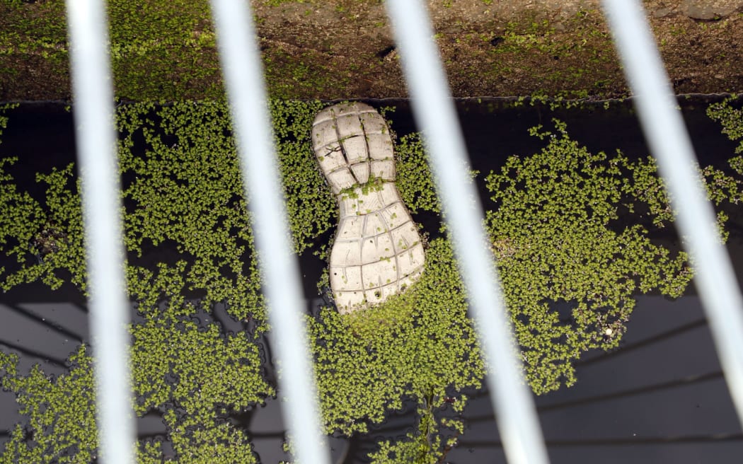 A shoe floats under a manhole at the stormwater site. SUPPLIED: ANTHONY PHELPS/STUFF - SINGLE USE ONLY