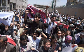 Afghan protesters during a protest against the government following a catastrophic truck bomb attack near Zanbaq Square in Kabul.