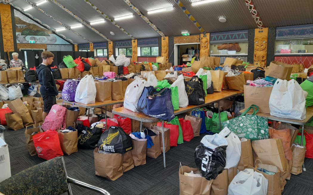 The wharenui is packed with bags ready to be picked up or delivered.