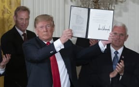 United States President Donald Trump displays Space Policy Directive 3.