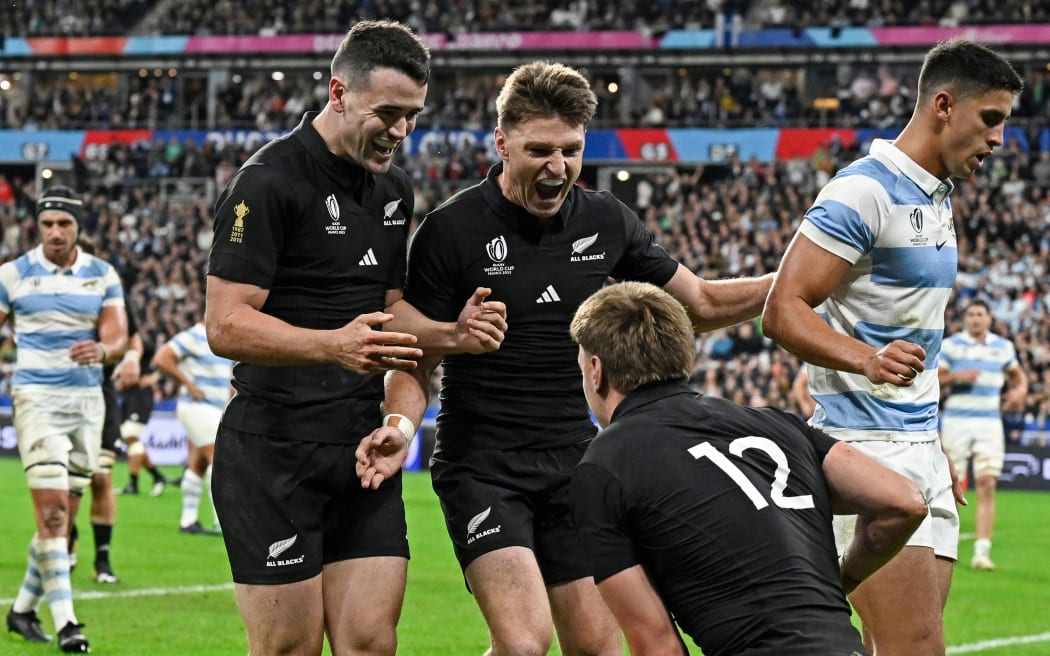 Will Jordan  and Beauden Barrett  celebrate a try by Jordie Barrett.