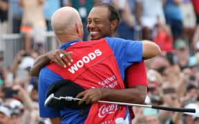 Tiger Woods hugs his caddie Joe LaCava, after winning the Tour Championship on September 23, 2018, at East Lake Golf Club in Atlanta.