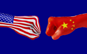 USA and China flag on fisted hands.