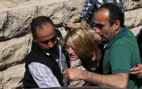 Australian TV reporter Tara Brown is escorted from a Lebanese courtroom.