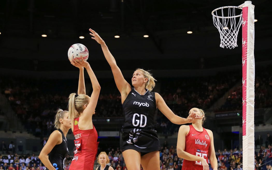 Helen Housby of England Roses lines up a shot challenged by Casey Kopua of New Zealand Silver Ferns