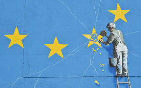 A mural by British artist Banksy depicting a workman chipping away at one of the stars on a European Union  themed flag. Dover, England, 7 January 2019.