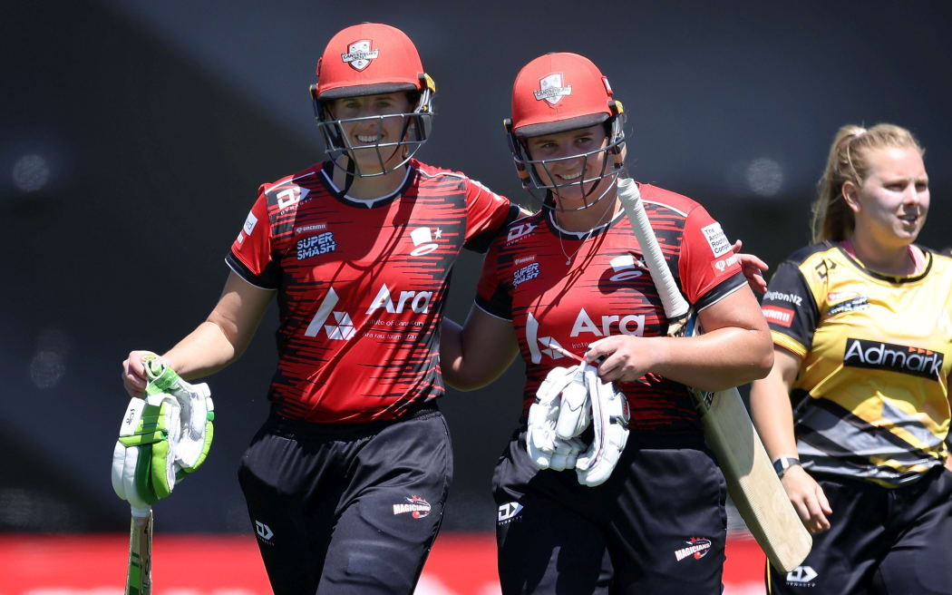 Magicians' Nat Cox (R) with team mate  Amy Satterthwaite walk from the field after their win during the Dream 11 Super Smash cricket match between the Wellington Blaze & Canterbury Magicians at the Basin Reserve in Wellington. 25 January 2021.