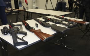 A selection of firearms which are now prohibited, on display to media at a police press conference.