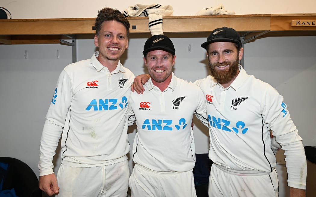 Michael Bracewell, Henry Nicholls and Kane Williamson in the New Zealand dressing room after their dramatic win over England at the Basin Reserve, 2023.