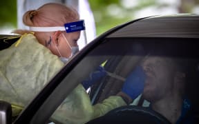 A healthcare worker tests a person at a drive-through Covid-19 testing clinic on the first day of a snap lockdown at Murarrie in Brisbane on January 9.