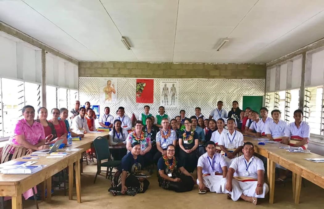 Mary Jane Kivalu (sitting on the floor at left) with the University of Otago delegation at Takuilau College in Lapaha, Tonga
