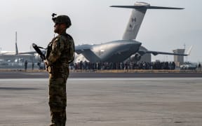 In this image courtesy of the US Air Force,, maintains a security cordon around a US Air Force C-17 Globemaster III aircraft in support of Operation Allies Refuge at Hamid Karzai International Airport (HKIA), Kabul, Afghanistan, on August 20, 2021.