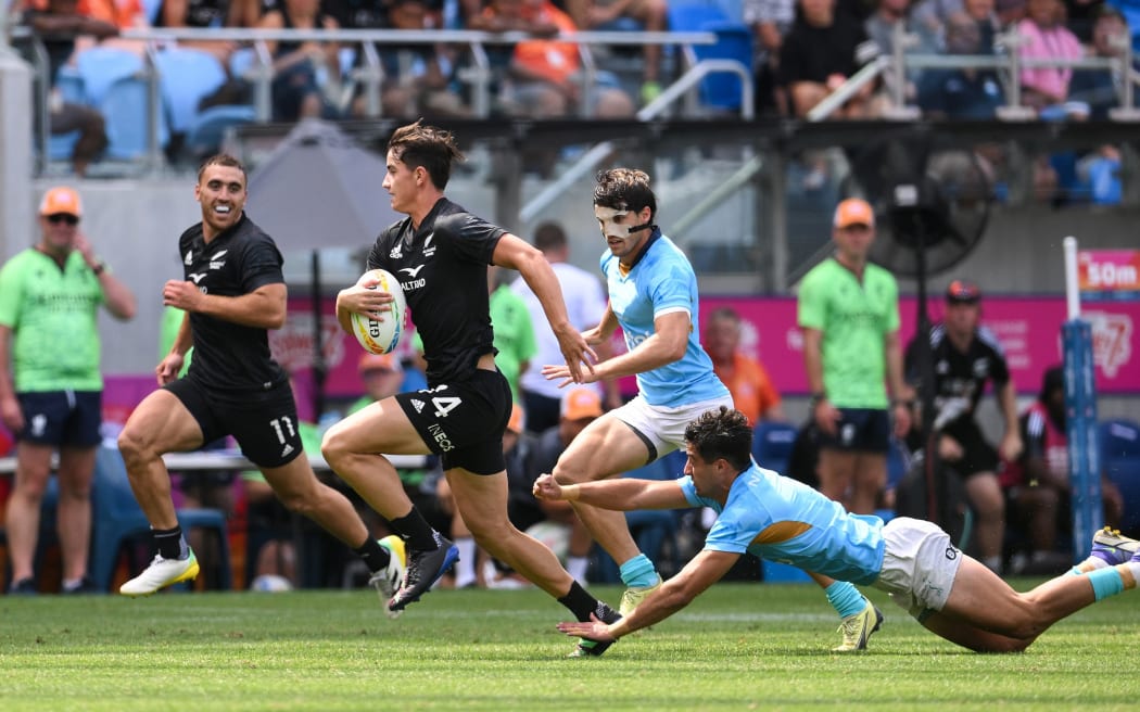 Payton Spencer of New Zealand runs the ball during the Sydney Sevens men's pool B rugby match against Uruguay in Sydney.