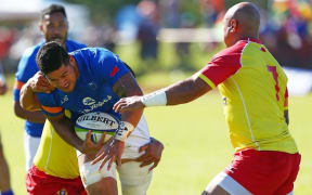 Tonga captain Nili Latu prepares to tackle Samoa's Jeff Lepa.