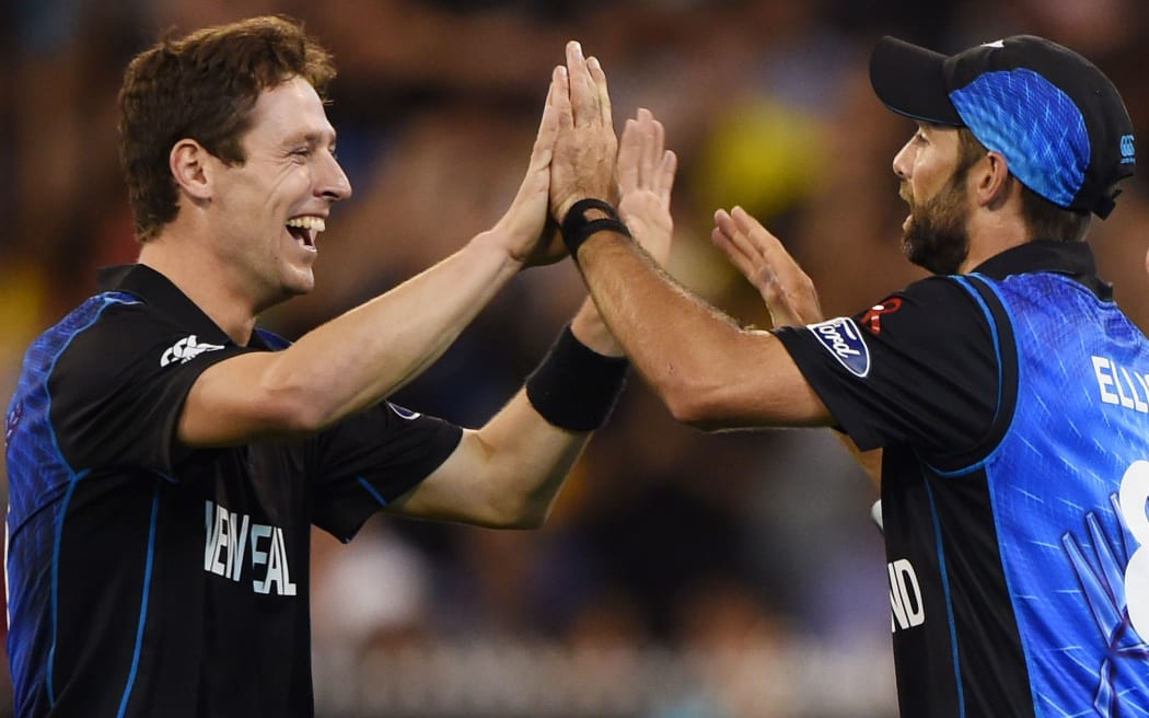 New Zealand's Matt Henry and Grant Elliott celebrate a wicket during the Cricket World Cup Final.