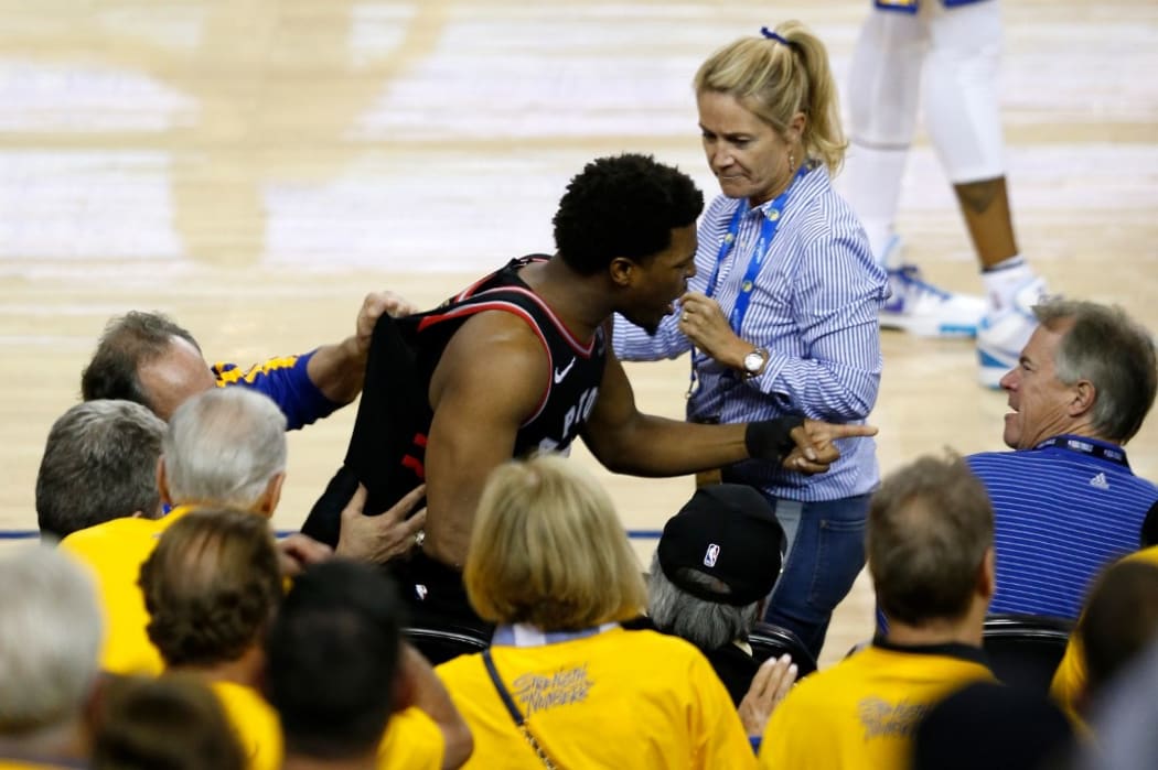 Kyle Lowry #7 of the Toronto Raptors yells at investor Mark Stevens in the second half against the Golden State Warriors during Game Three of the 2019 NBA Finals.