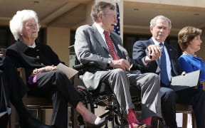 George H W Bush (centre) with wife Barbara and son George W Bush.