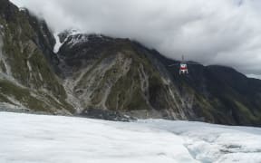 Helicopter landing on Franz Josef Glacier, South Island.
