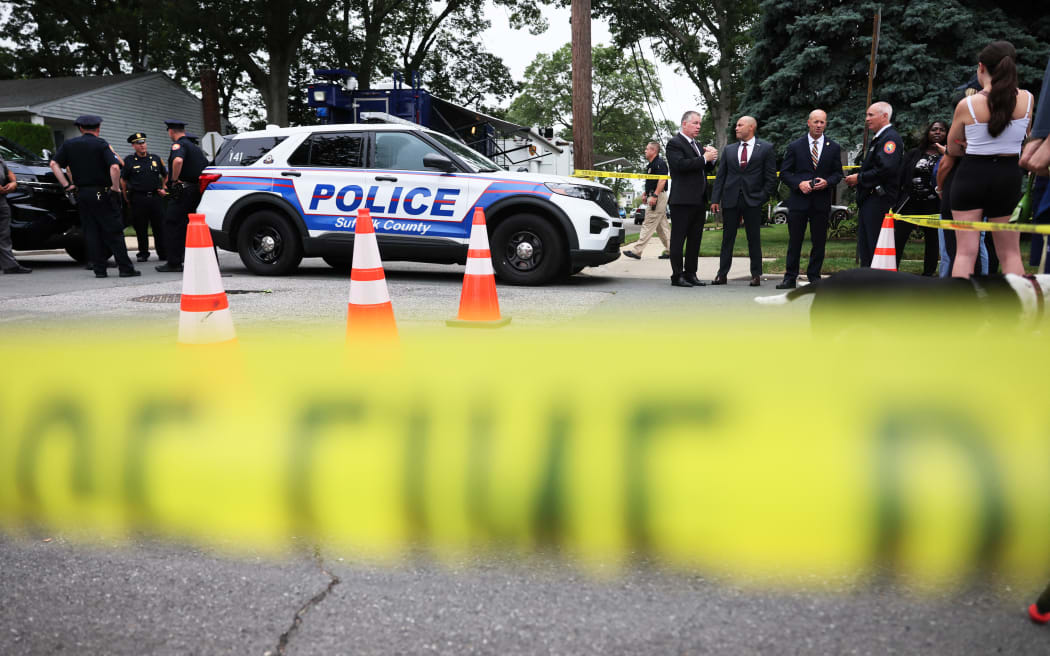 Law enforcement officials are seen as they investigate the home of a suspect arrested in the unsolved Gilgo Beach killings on July 14, 2023 in Massapequa Park, New York. A suspect in the Gilgo Beach killings was arrested in the unsolved case tied to at least 10 sets of human remains that were discovered since 2010 in suburban Long Island. The suspect Rex Heuermann is expected to be arraigned after his arrest Thursday night.