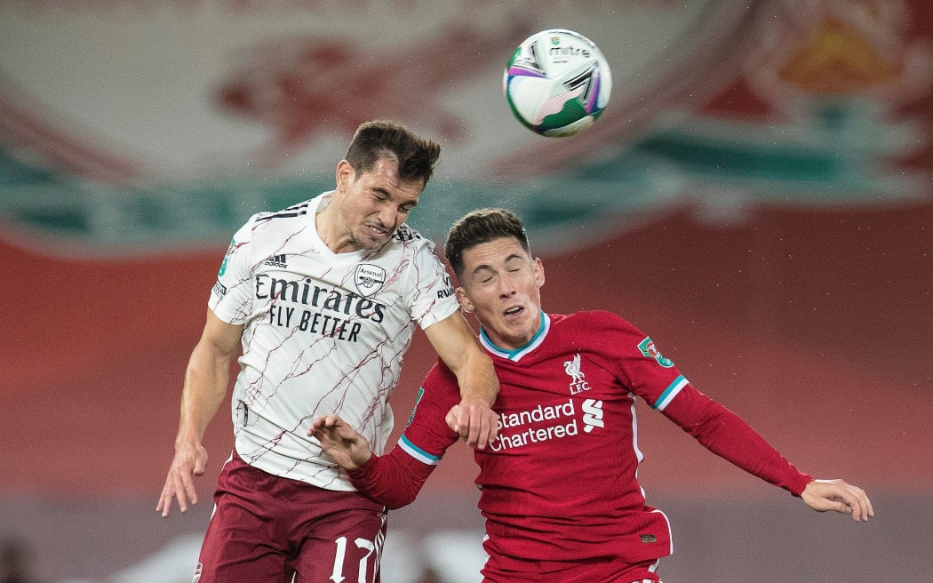 Cedric Soares of Arsenal and Harry Wilson of Liverpool compete for a header