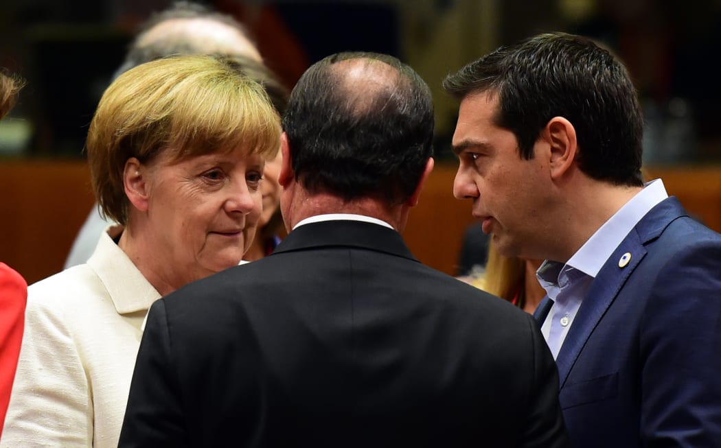 German Chancellor Angela Merkel, French President Francois Hollande (centre) and Greek Prime Minister Alexis Tsipras confer prior to the start of the summit in Brussels.