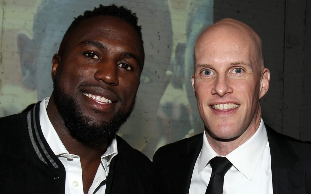 In this file photo taken on January 9, 2017, US sportswriter Grant Wahl (R) and US soccer player Jozy Altidore (L) attend the 2017 St. Luke Foundation for Haiti Benefit hosted by Kenneth Cole at the Garage in New York City. - The veteran journalist died in Qatar today after he collapsed while covering the World Cup semi-finals match between Argentina and the Netherlands. Wahl was detained earlier in the tournament by security guards when he attempted to enter the match between the US and Wales while wearing a shirt with a soccer ball surrounded by a rainbow. (Photo by Mike Lawrie / GETTY IMAGES NORTH AMERICA / AFP)