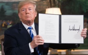 US President Donald Trump signs a document reinstating sanctions against Iran after announcing the US withdrawal from the Iran Nuclear deal.