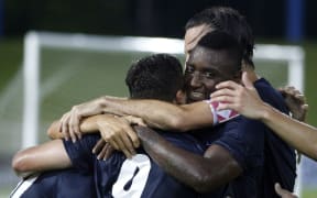 Auckland City players celebrate a goal.
