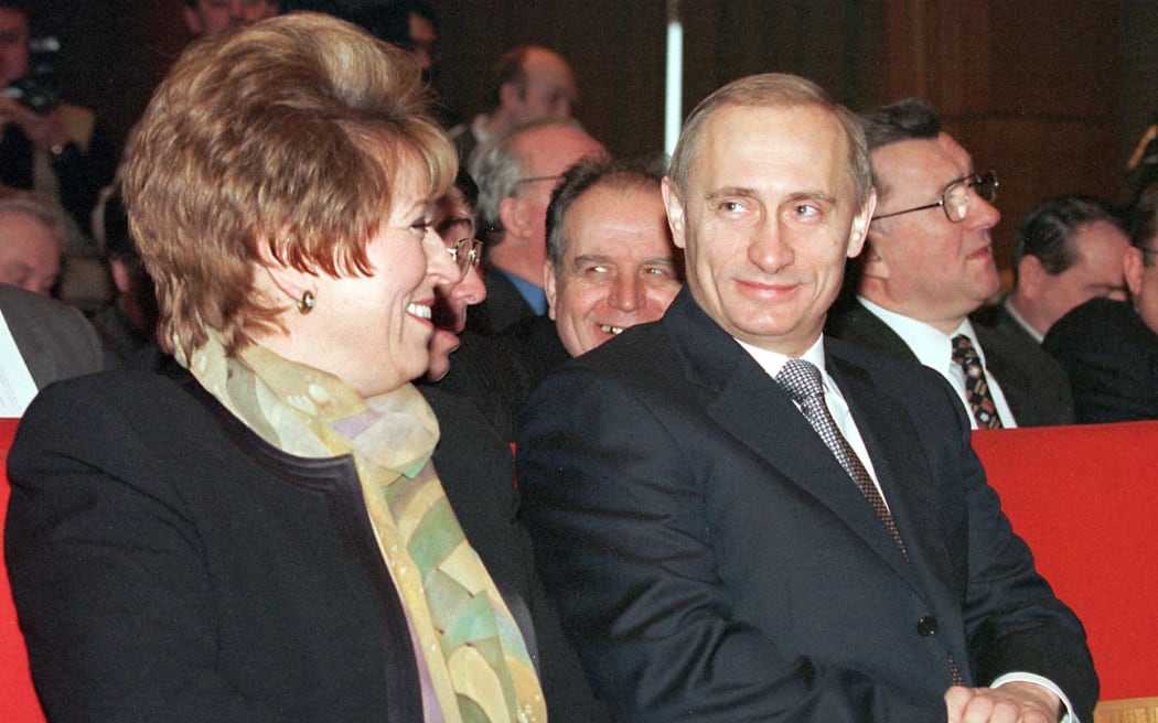 Russian acting President Vladimir Putin (R) and Vice Premier Valentina Matviyenko (L) smile during the session of the trade unions general council, Moscow 16 February, 2000.
