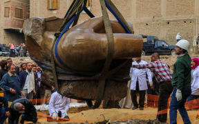 The torso being unearthed in Cairo.