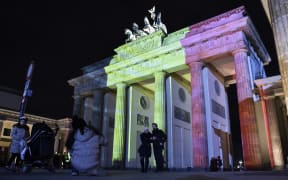 The colors of the Belgian flag are projected on to the Brandenburg Gate in Berlin as the German capital shows its solidarity following the Brussels attacks.