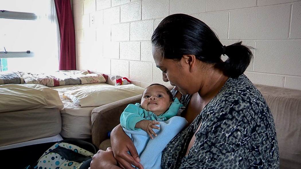 Nicole and her youngest child, who are paying $190 per night in emergency housing at a motel