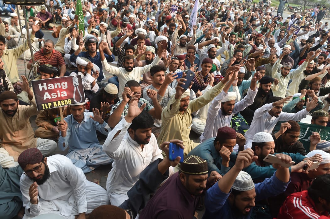 Crowds chant slogans during a protest against the court decision to overturn the conviction of Christian woman Asia Bibi