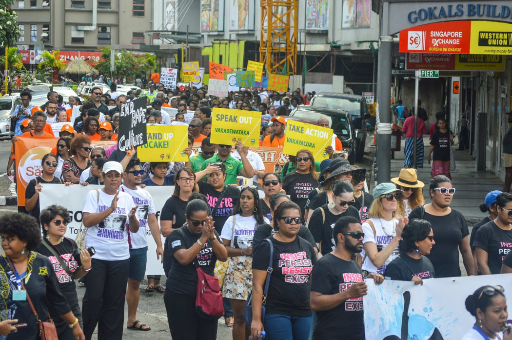 Locals rally against gender-based violence.