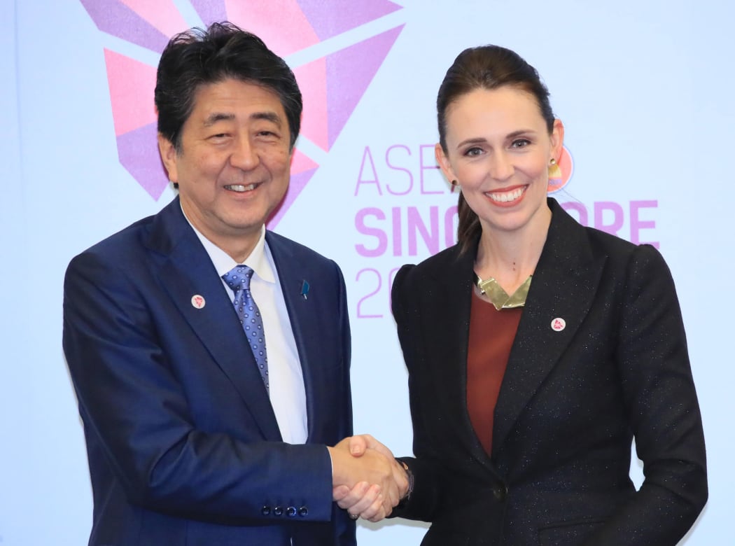 Japan's Prime Minister Shinzō Abe (L) shakes hands with New Zealand Prime Minister Jacinda Ardern prior to their summit meeting in Singapore.
