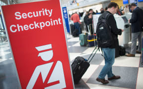 A sign directs travellers to a security checkpoint staffed by Transportation Security Administration (TSA) workers at O'Hare Airport in Chicago, Illinois in June 2015.
