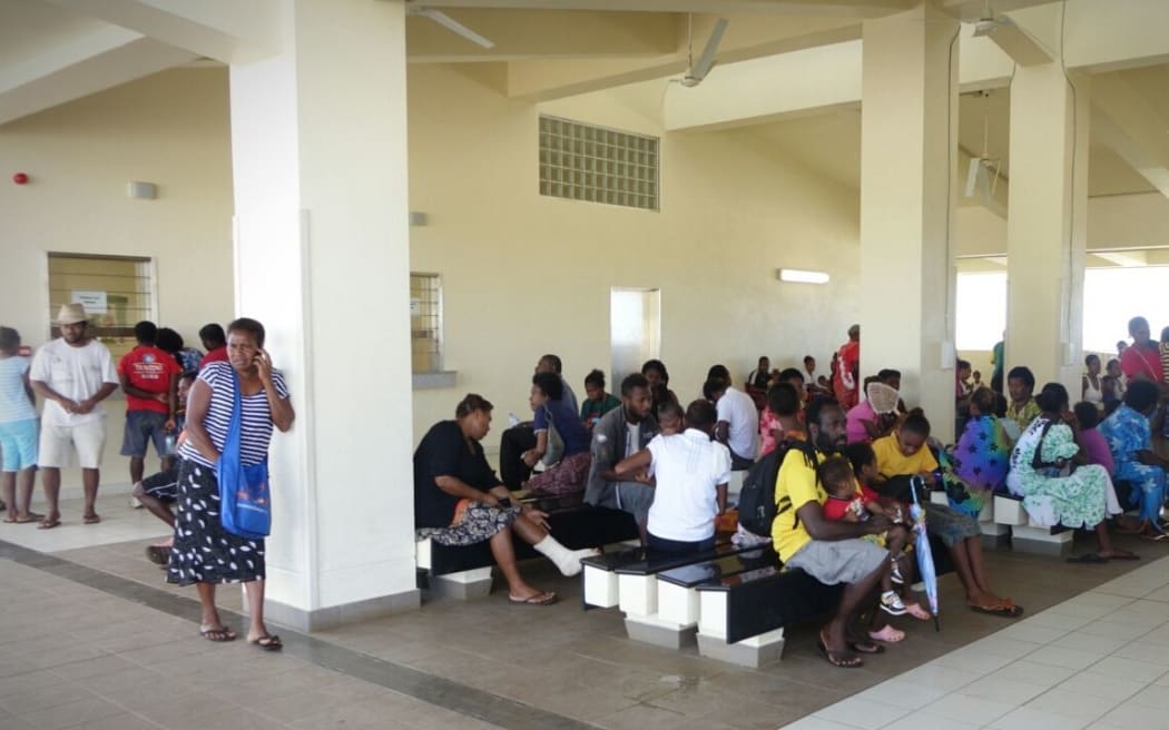 People wait to be seen at the main hospital in Port Vila after Cyclone Pam. One wing was left standing.