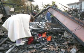 A house has burned down after a massive quake in Masaki, Kumamaoto Prefecture, western Japan on April 15, 2016.