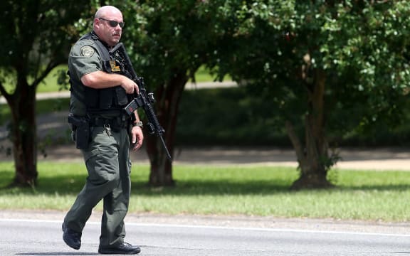 A police officer patrols in Baton Rouge Police after three officers were killed in a shooting.