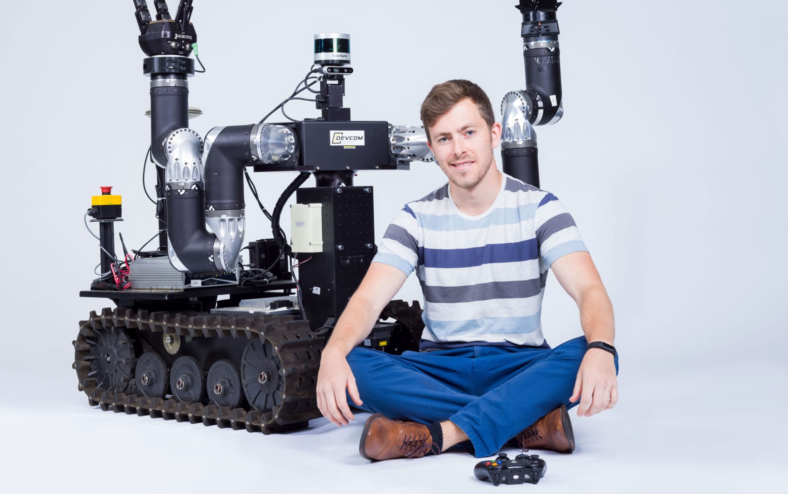 JPL Robotics Technologist Joseph Bowkett poses with RoMan.