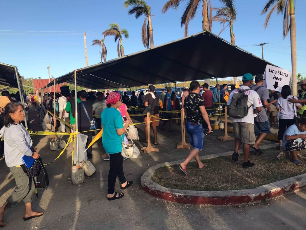 People lining up for food stamps in the CNMI after Typhoon Yutu
