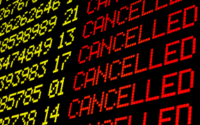 Cancelled flights on airport board panel