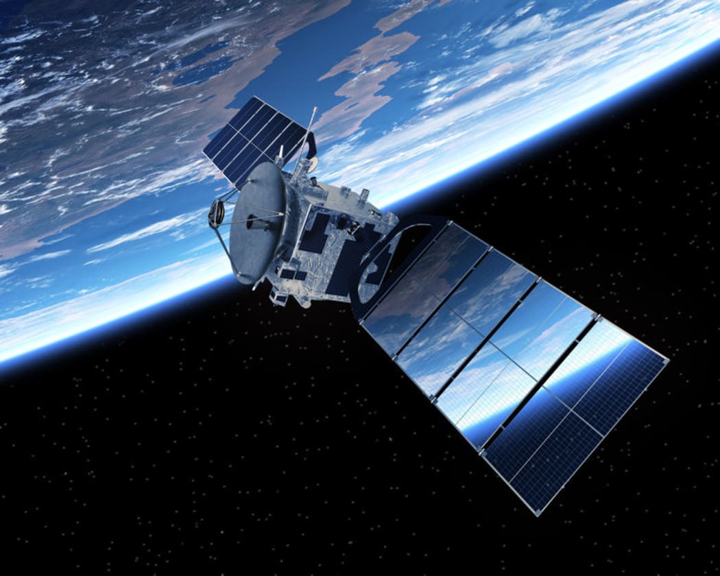 A communication satellite orbiting the earth.