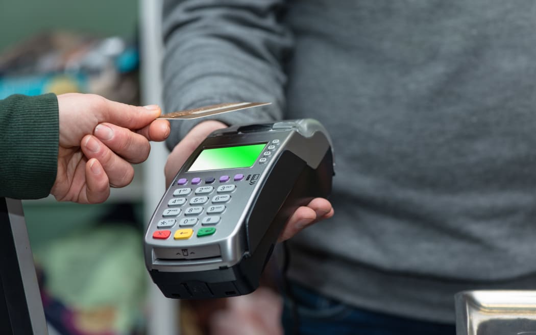 NFC technology, the customer makes payment by contactless credit card.  The credit card reader implements payment execution, in the store