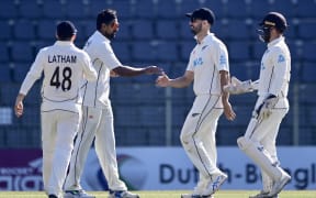 New Zealand’s Ish Sodhi (2L) celebrates with teammates after picking up a wicket in first test against Bangladesh, Sylhet, 2023.