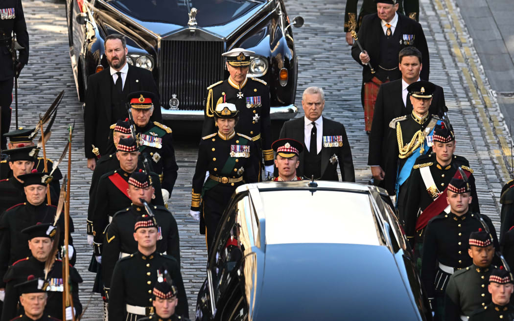 Britain's King Charles III flanked by Britain's Princess Anne, Princess Royal, Britain's Prince Andrew, Duke of York and Britain's Prince Edward, Earl of Wessex, walk behind the procession of Queen Elizabeth II's coffin, from the Palace of Holyroodhouse to St Giles Cathedral, on the Royal Mile on September 12, 2022, where Queen Elizabeth II will lie at rest.